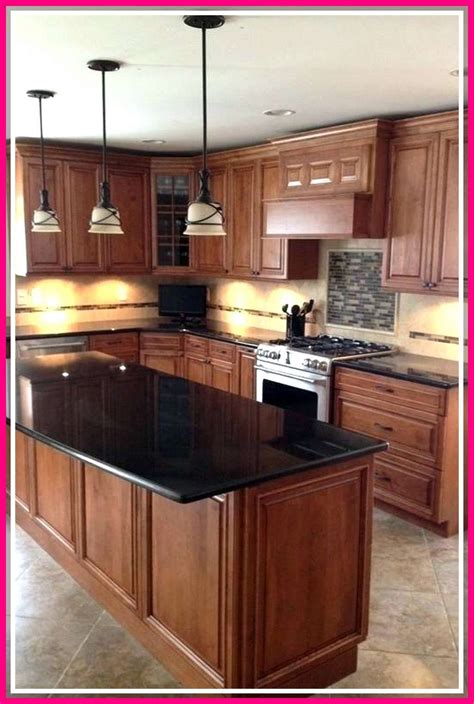 black stainless steel appliances with light oak cabinets|oak cabinets with black hardware.